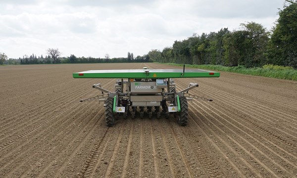 Rear view of four-wheeled FarmDroid FD20 weeding onions in the UK